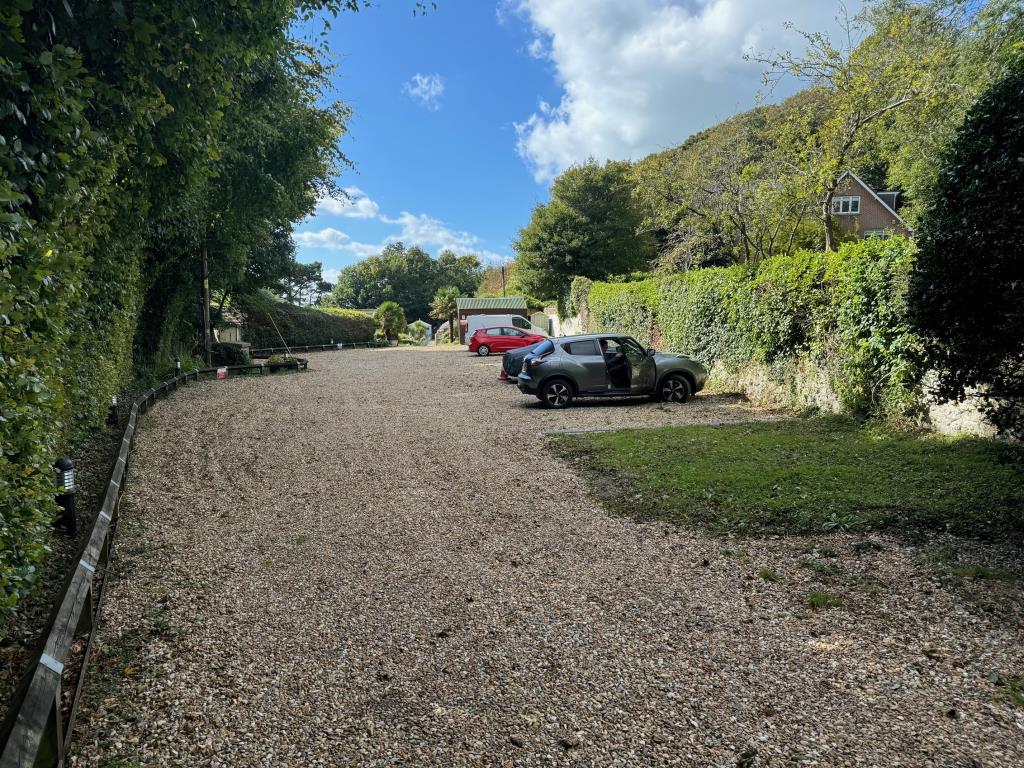 Lot: 59 - FREEHOLD GROUND RENTS FOR EXTENSIVE CHALET SITE - Gravel car parking area